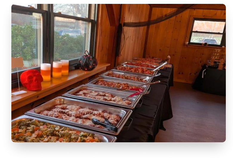 Catering spread with grilled meats and sides